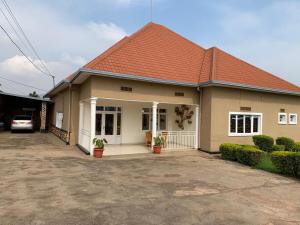 a house with a red roof and a driveway at Inkindi House in Kigali