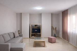a living room with a couch and a tv at Dahlila's Home near Lake Ohrid in Pogradec