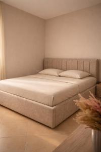 a bed with two pillows in a room at Dahlila's Home near Lake Ohrid in Pogradec