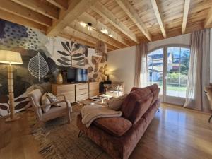 a living room with a couch and two chairs at Les hauts de LOUVIE in Louvie-Soubiron