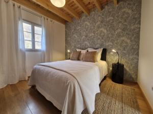 a bedroom with a bed and a wall mural at Les hauts de LOUVIE in Louvie-Soubiron