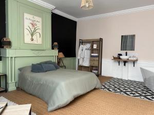 a bedroom with a bed and a dresser in it at Casa 17 Confolens in Confolens +10 photos