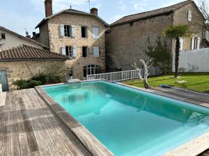 a swimming pool in front of a house at Casa 17 Confolens in Confolens
