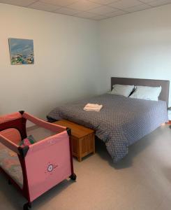 a bedroom with a bed and a table with a drawer at L'Arbre de Vie in Montmarault