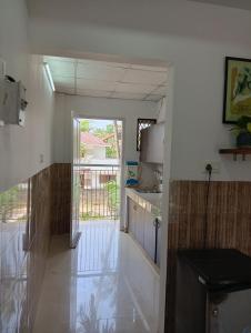 a kitchen with a door leading to a balcony at Orchid Woods Garden in Trivandrum
