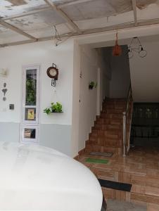 a room with stairs and a clock on the wall at Orchid Woods Garden in Trivandrum