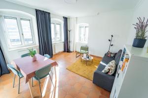 a living room with a couch and a table at Wohnen bei Schörgi in Grein +41 photos
