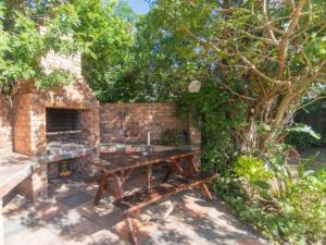 a picnic table in front of a brick wall at Amani Guest Lodge in Port Elizabeth