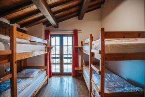 a room with three bunk beds and a window at Le Grand Cerf 25 pers, Malmedy- Chalet rustique, jardin in Malmedy