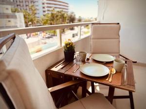 a table with plates and cups on a balcony at Valparaíso Apartments Flamingo in San Bartolomé
