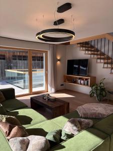a living room with a couch and a table at MALIA - Alpine Hideaway in Pertisau +58 photos