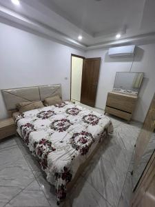 a bedroom with a bed and a dresser and a mirror at Assef home in Midoun