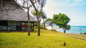 a house on a hill with a view of the ocean at Amani Beach Resort in Dar es Salaam