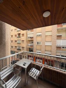 a balcony with a table and chairs and a building at Hotel Carlos III in Águilas +13 photos