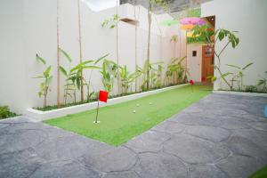 a golf course with a red flag in a building at Among Villa Demangan in Yogyakarta