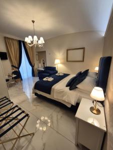 a bedroom with a large bed and a living room at Napoli Sogno Infinito in Naples