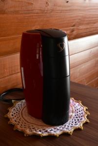 a red coffee cup sitting on a table at Cabanas Lago - Piratuba-SC in Piratuba +19 photos