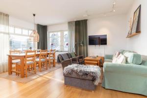 a living room with a couch and a dining room at Åre Travel - Brygghusen in Åre