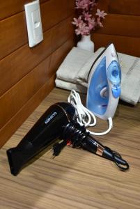a hair dryer on the floor next to a room at Cabanas Lago - Piratuba-SC in Piratuba