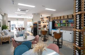 a room with a table and chairs and a wine cellar at Palm Beach Club Apartamentos Carihuela in Torremolinos