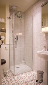 a bathroom with a shower and a sink at Costers Lodge in Midhurst