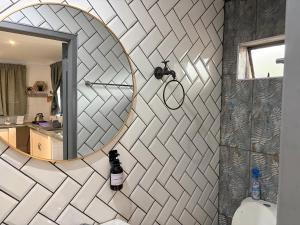a bathroom with a mirror and a toilet at Evening Star Guest Units in Fichardtpark +43 photos