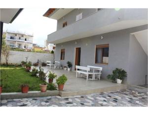 a patio of a house with chairs and plants at Diar Sea House in Orikum