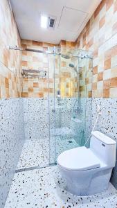 a bathroom with a glass shower and a toilet at Ha Anh Villa Ninh Binh in Ninh Binh