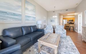 a living room with a couch and chairs and a table at Phoenix VI 6004 in Orange Beach