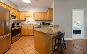 a kitchen with wooden cabinets and a granite counter top at Phoenix VI 6004 in Orange Beach