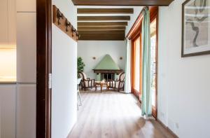 a hallway with a fireplace in a house at Parco Hermitage - Vila Camelia in Porto Valtravaglia