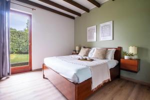 a bedroom with a bed with a tray on it at Parco Hermitage - Vila Camelia in Porto Valtravaglia +19 photos