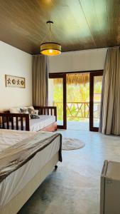 a bedroom with two beds and a large window at Vila Marina Icaraizinho in Icaraí +24 photos