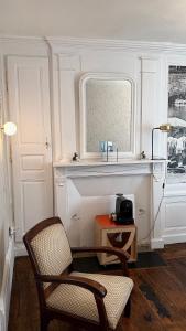 a room with a chair and a table and a window at Maison d'hôte Les Allois in Limoges +61 photos