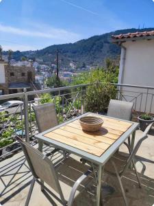 a table and chairs on a balcony with a view at Reborn Project Acropolis in Skiathos
