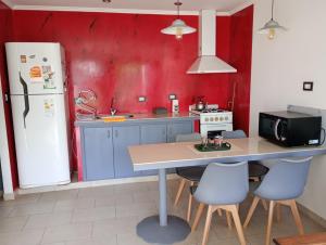a kitchen with a table and a refrigerator at Las ruinas 1 in Carhué