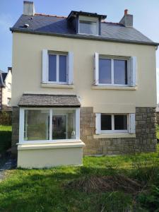 a house with a large window on the side of it at Maison à L'île Grande in Pleumeur-Bodou