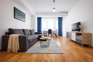 a living room with a couch and a table at Urban Serviced Apartments in Skopje