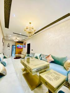 a living room with a couch and a table at New dream home in Fez