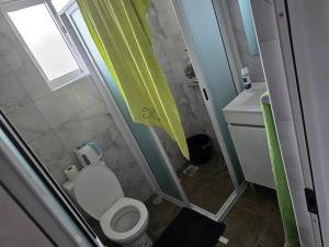 a small bathroom with a toilet and a sink at Chez Fortes in Porto Novo