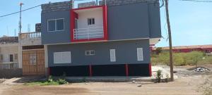 a building with a red door on the side of it at Chez Fortes in Porto Novo +5 photos