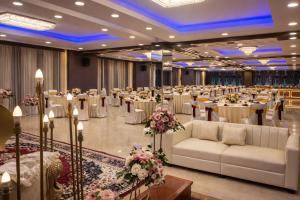 a banquet hall with tables and chairs in a ballroom at Pavitram Hotel & Banquet in Rānchī