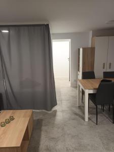 a living room with a table and a window at Kawalerka Perzycka in Poznań