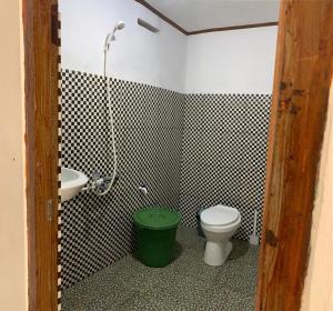 a bathroom with a toilet and a sink at Heiner Beach Homestay in Bunaken