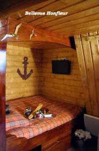 a small room with a bed in a log cabin at Le Bellevue Honfleur in Honfleur
