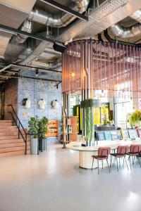 a lobby with chairs and a table in a building at The Social Hub Delft in Delft +36 photos