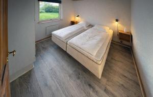 a bedroom with a bed and a window in it at Nice Home In Oksbøl With Sauna in Oksbøl