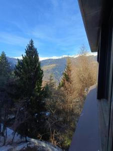 a view of the mountains from a balcony of a house at Marilleva 1400 - Alpine Apartment in Marilleva
