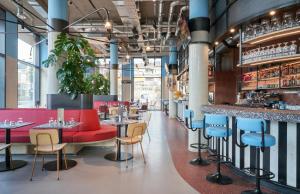 a restaurant with red and blue chairs and tables at The Social Hub Delft in Delft