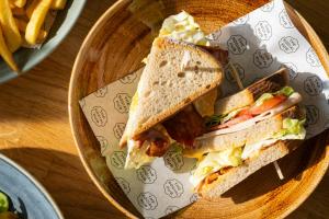 two sandwiches on a plate with french fries at The Social Hub Rotterdam in Rotterdam